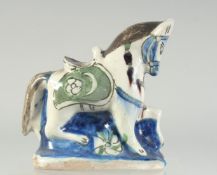 A 19TH CENTURY TURKISH KUTAHYA GLAZED POTTERY HORSE, 18cm long.