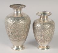 TWO PERSIAN WHITE METAL VASES, one drilled and weighted, 18cm and 15cm, (2).