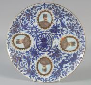 A QAJAR BLUE AND WHITE PORCELAIN PLATE, with four portrait medallions and foliate decoration, 26cm