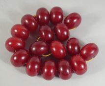 A LARGE BEADED CHERRY AMBER / BAKELITE NECKLACE.