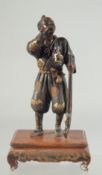 A JAPANESE SIGNED GILT BRONZE OKIMONO ON HARDWOOD STAND, signed Miyao Eisuke, 20cm high overall.