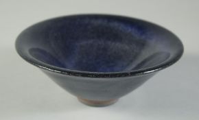 A CHINESE BLUE GLAZE POTTERY BOWL, incised character mark to base, 15cm diameter.