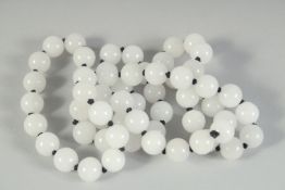 A STRING OF WHITE JADE BEADS. 30ins long.