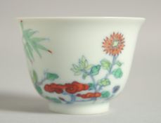 A CHINESE DOUCAI PORCELAIN CUP, with floral decoration and six-character mark, 6cm diameter.