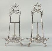 A LARGE PAIR OF SILVERED EASELS 20ins high.
