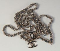 A GOOD LONG CHANEL LEATHER THROUGH THE CHAIN BELT with three double C medallions. 3ft 9ins long.