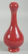 A CHINESE RED GARLIC TOP VASE. 7ins high.