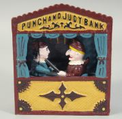 A CAST IRON PAINTED PUNCH AND JUDY BANK. 7ins high.