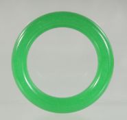 AN APPLE GREEN JADE BANGLE. 8cm diameter.