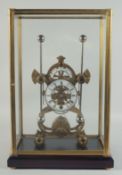A GOOD BRASS GRASSHOPPER SKELETON CLOCK with white enamel dial, in a glass case. 19ins high
