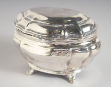 AN EDWARD VII BOMBE SHAPED SILVER TEA CADDY AND COVER. 4.75ins long, 3.5ins deep, supported on