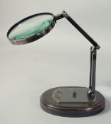WATT & SONS LTD. A BRONZED MAGNIFYING GLASS on a stand.
