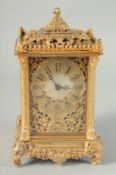 A GILT BRONZE CLOCK in an ornate case with elephant supports. 6ins high.
