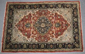 A PERSIAN PART SILK RUG with a stylised floral decoration. 135cm x 81cm.