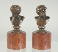 F. BARBEDIENNE. A PAIR OF MINIATURE BRONZE BUSTS, on wooden bases. 2ins high. signed.