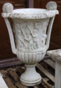 A LARGE PAIR OF ITALIAN CARVED WHITE MARBLE TWO HANDLED URNS. The sides carved with cupids depicting