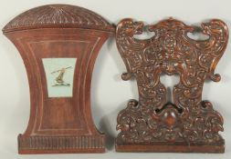TWO CAMPUR WOOD PANELS ARMORIAL AND GREEN MAN.