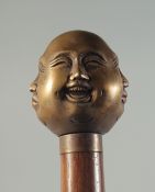 A WOODEN WALKING STICK with brass FOUR FACES HANDLE.