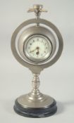 A RARE INDUSTRIAL METAL DRUM CLOCK AND BAROMETER. The swivel top with a compass, on a circular base.