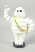 A SMALL IRON MICHELIN MAN MONEY BOX. 9ins high.