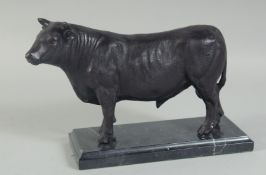A BRONZE BULL on a marble base. 10ins high.