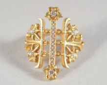 AN 18CT GOLD LALOUNIS DIAMOND SET CROSS PIERCED RING.