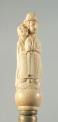 A CARVED BONE HANDLED WALKING STICK 