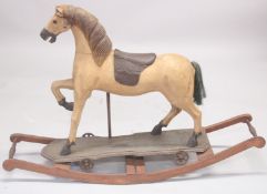 A OLD CARVED WOODEN ROCKING HORSE. 4ft high.