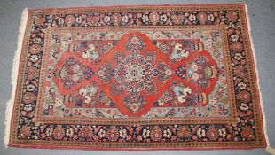 A VERY GOOD PERSIAN FLORAL RUG on a red ground. 135cm x 210cm.