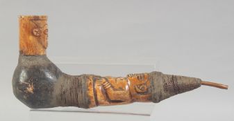 A NATIVE CARVED BONE METAL AND FIBRE PIPE. 14ins long.