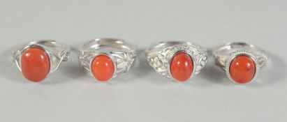 FOUR SILVER AND CORAL RINGS,