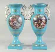 A LARGE PAIR OF LIGHT BLUE SEVRES STYLE TWO HANDLED VASES with griffin handles and oval classical
