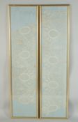A PAIR OF LONG FRAMED AND GLAZED LACE PANELS 33ins x 7ins.