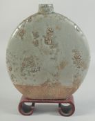 A CHINESE CELADON MOON FLASK on a wooden stand. 10ins high.