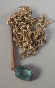AN AQUAMARINE PENDANT on a gold chain.