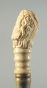 A CARVED BONE HANDLED WALKING STICK 