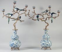A VERY GOOD PAIR OF PORCELAIN AND GILT METAL BIRD DOUBLE GOURD VASES with branches and birds.