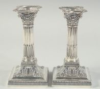 A GOOD PAIR OF VICTORIAN CORINTHIAN COLUMN CANDLESTICKS with bead edge. 6.5ins high. Sheffield 1900.