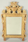 AN 18TH CENTURY ITALIAN GILTWOOD MIRROR with urn and flora surmount. 2ft 4ins high, 1ft 7ins wide.