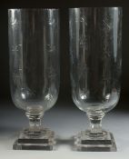 A GOOD PAIR OF STAR CUT GLASS HURRICANE LAMPS on square bases. 15.5ins high.
