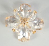 A LARGE CHANEL EIGHT PETAL FLOWER BROOCH with CC in diamante, in a Chanel box. 4.5cm diameter.