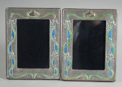 A PAIR OF ART DECO DESIGN SILVER AND ENAMEL PHOTOGRAPH FRAMES. 7.5ins x 5.5ins.