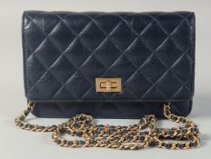 A CHANEL DARK BLUE PADDED CLUTCH BAG. 7.5ins long, 4.5ins high with gilt and leather straps. 24ins
