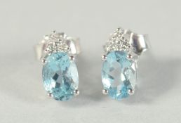 A PAIR OF 18CT WHITE GOLD AQUAMARINE AND DIAMOND EARRINGS.