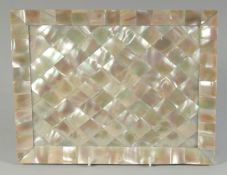 A GOOD RECTANGULAR MOTHER OF PEARL TRAY on ball feet. 11ins x 9ins.