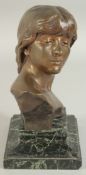 INGALBAIT. A GOLDSCHEIDER BRONZE BUST OF A YOUNG GIRL. Signed. 6.5ins high on a marble base.