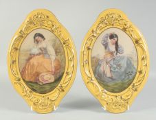 A PAIR OF SEVRES STYLE OVAL YELLOW WALL PLAQUES with portraits of a young lady. 1ft 3ins long.