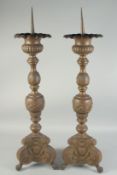 A LARGE PAIR OF DUTCH BRONZE PRICKET CANDLESTICKS. 3ft high.