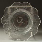 A LALIQUE BOWL 3cm deep, the sides with flowers. Signed, 15cm diameter in a Lalique box.