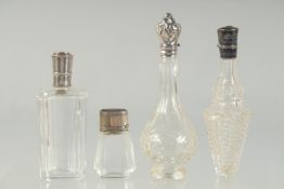 FOUR SILVER TOP SCENT BOTTLES.
